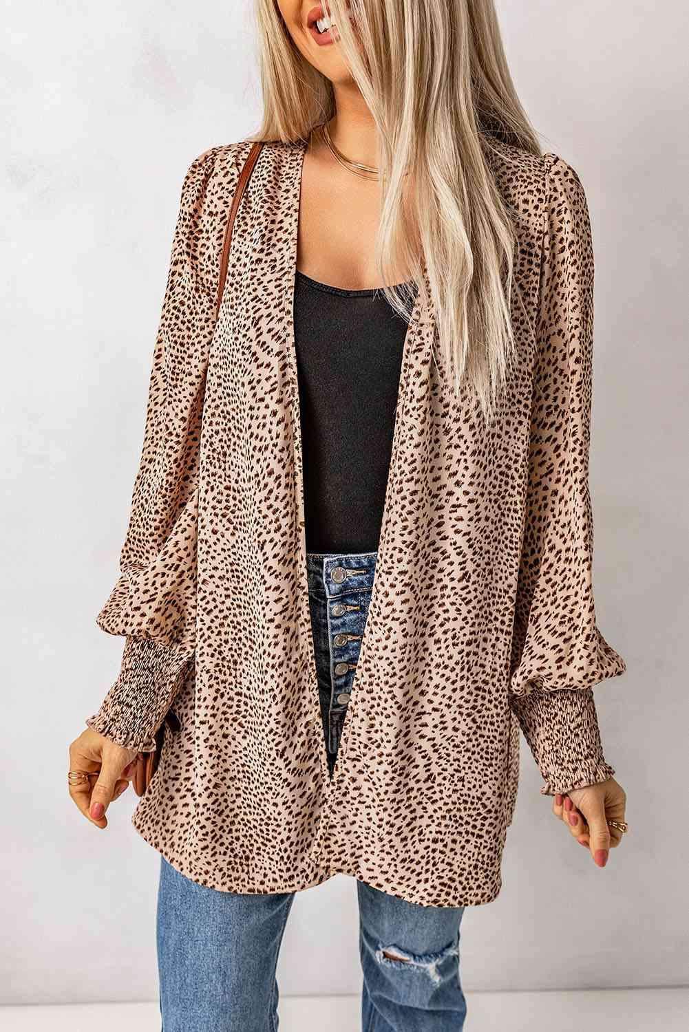 a woman wearing a leopard print jacket