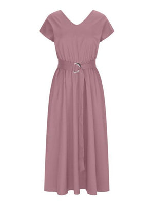 a woman wearing a pink dress with a belt