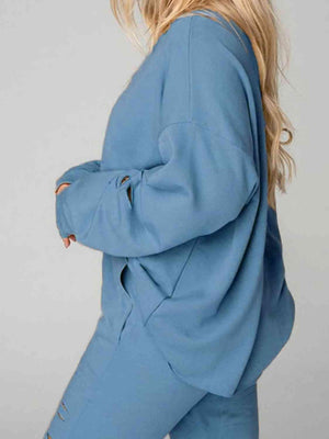 a woman wearing a blue sweatshirt and sweatpants