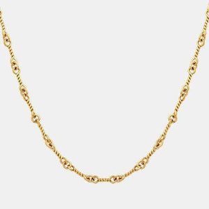 a gold necklace with a chain on a white background