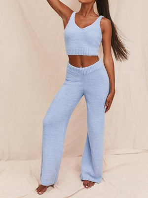 a woman in a blue crop top and pants