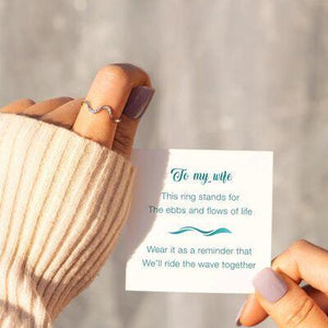 a person holding a card with a message on it