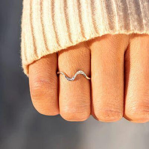a woman's hand with a ring on it