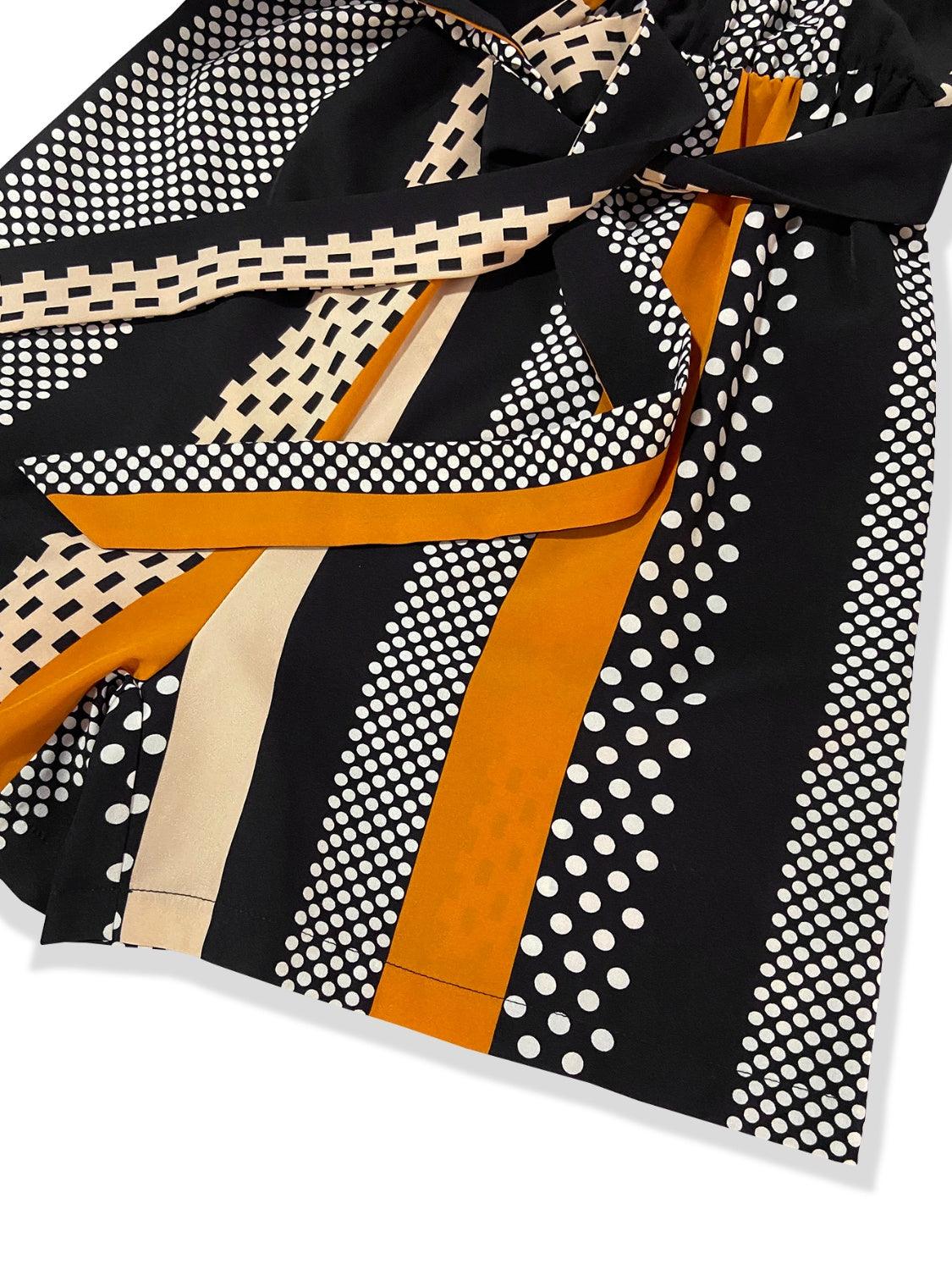 a close up of a tie on a white surface