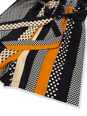 a close up of a tie on a white surface