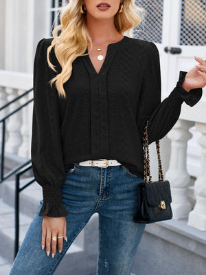 a woman wearing a black blouse and jeans