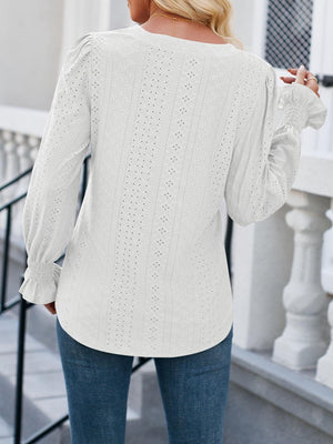 a woman wearing a white sweater and jeans