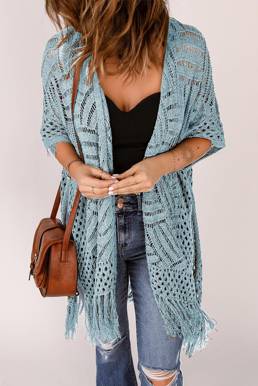 a woman wearing a blue crochet cardigan sweater