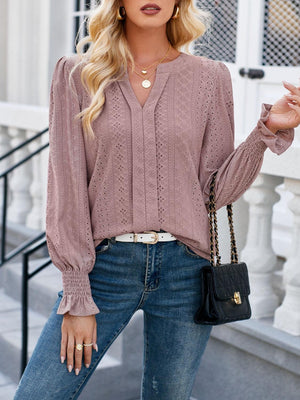 a woman wearing a pink sweater and jeans