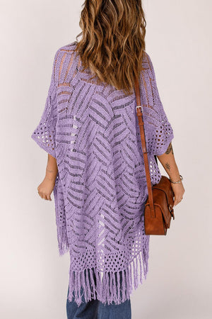 a woman wearing a purple crochet ponchy