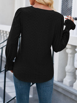 a woman wearing a black sweater and jeans
