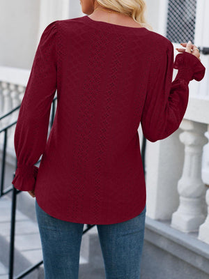 a woman wearing a red sweater and jeans