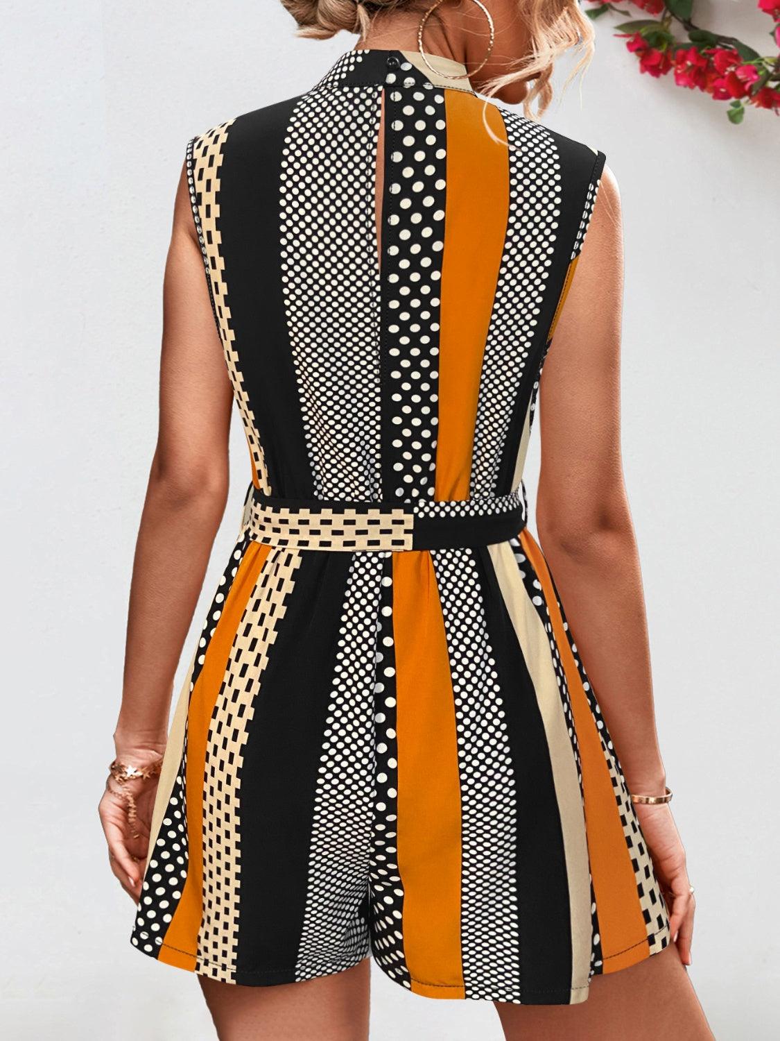 a woman wearing a black, orange and white romper