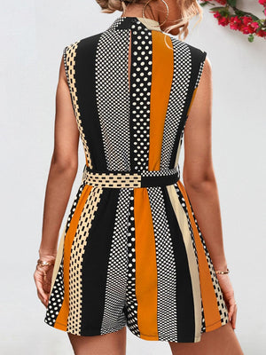 a woman wearing a black, orange and white romper