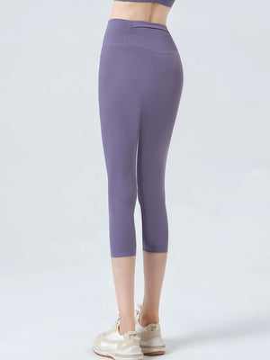 a woman in a purple top and leggings