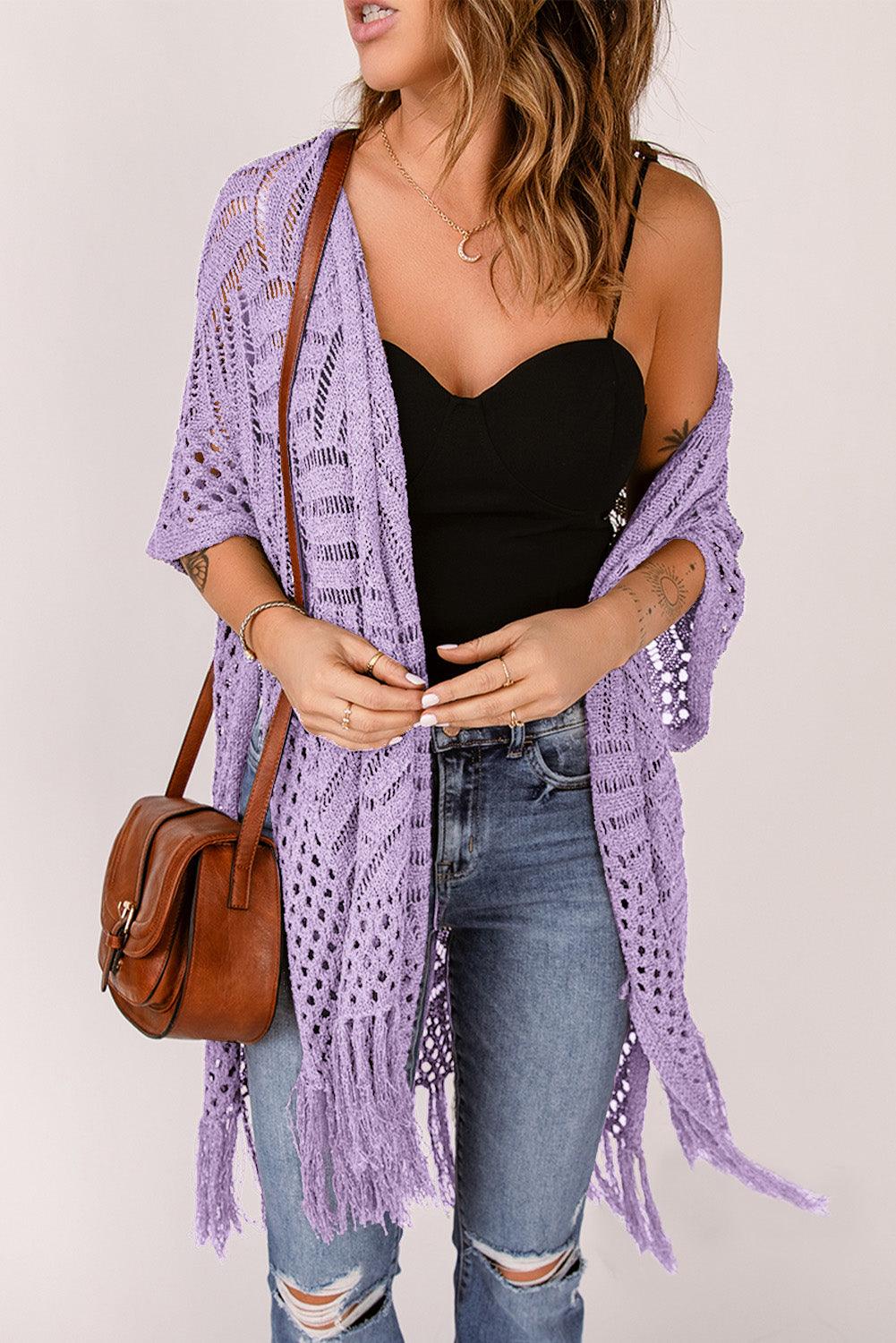 a woman in a black top and a purple shawl