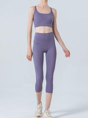 a woman in a purple sports bra top and leggings