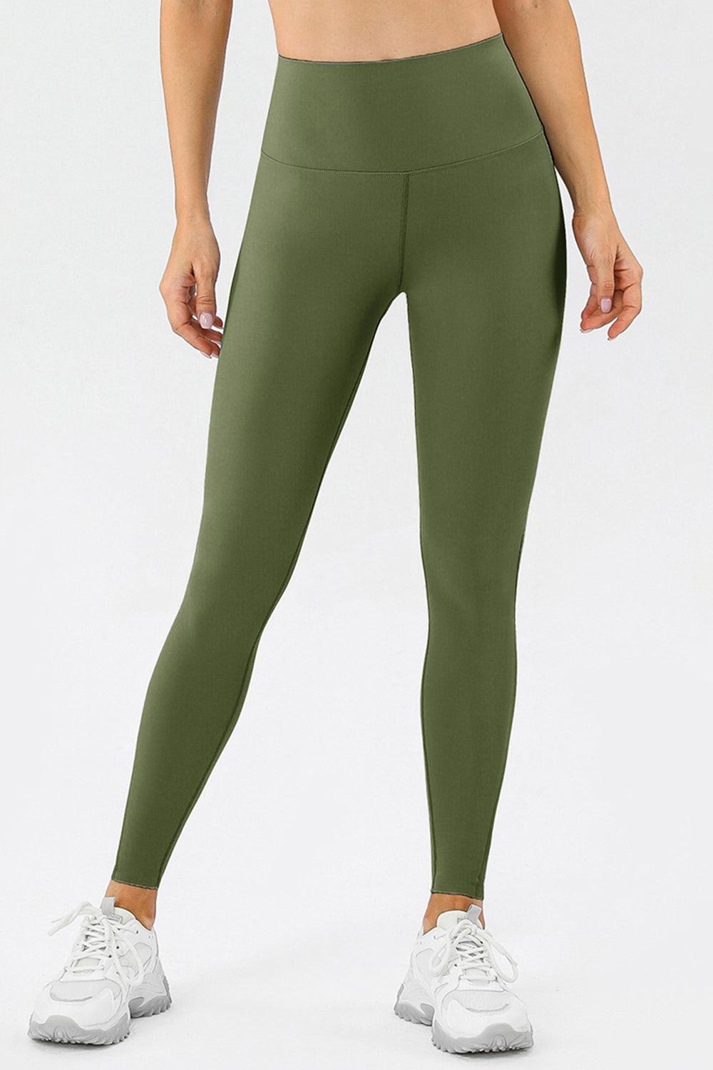 a woman in a sports bra top and green leggings