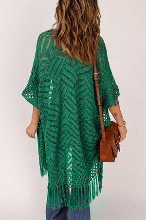 a woman is wearing a green crochet sweater