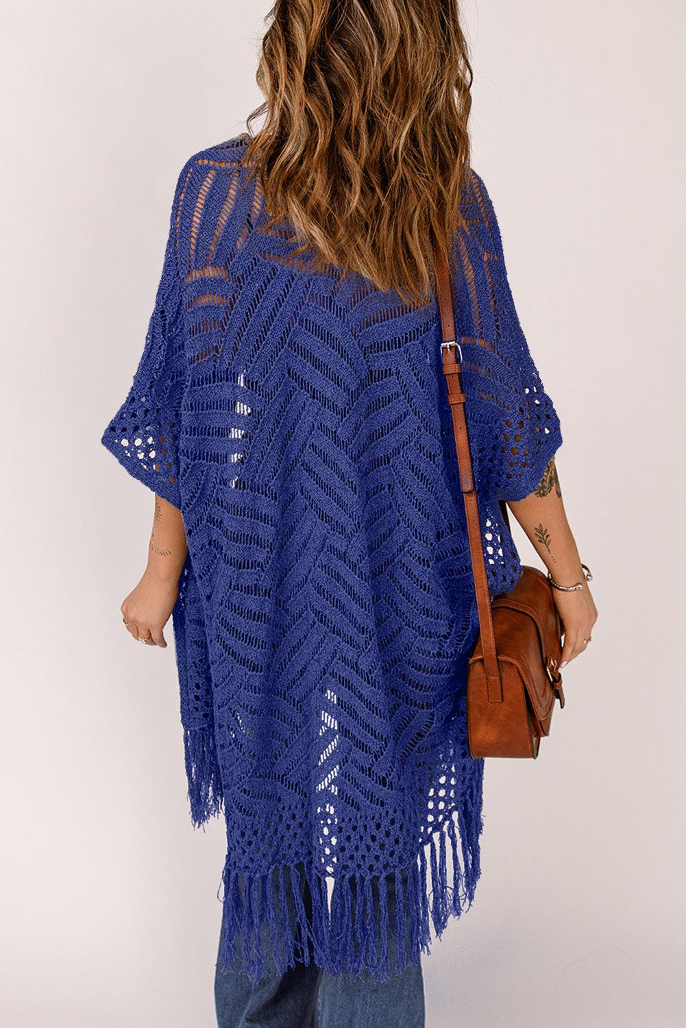 a woman is wearing a blue crochet ponchy