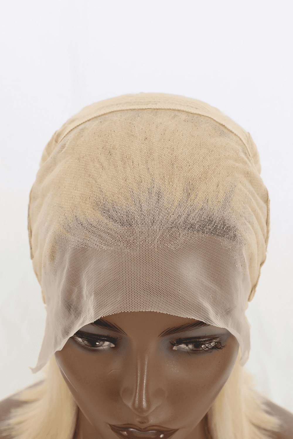 a mannequin head wearing a wig with a veil over it