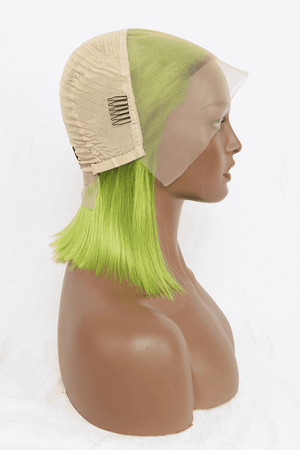 a mannequin head wearing a wig with green hair