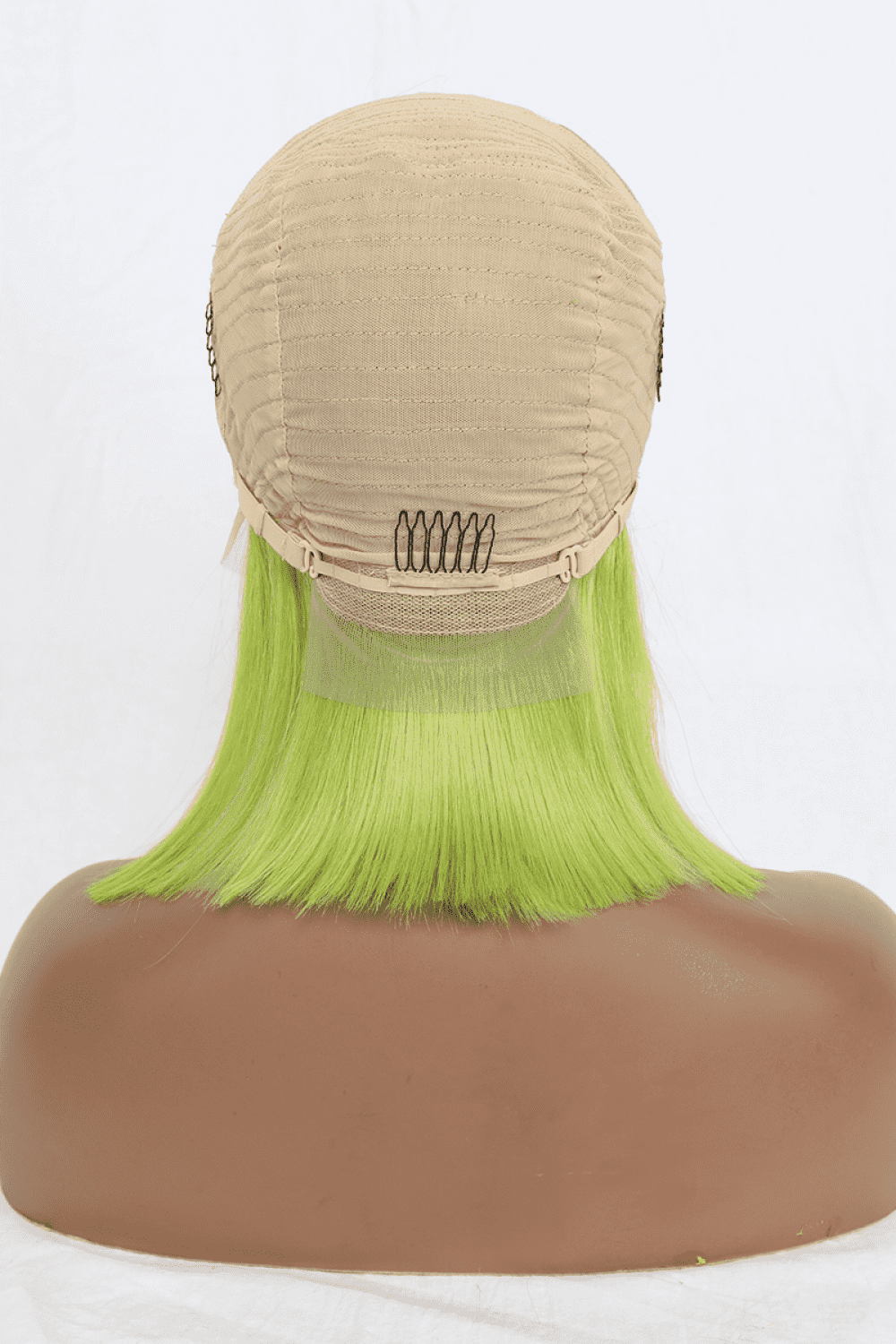 a wig with green hair on a mannequin head