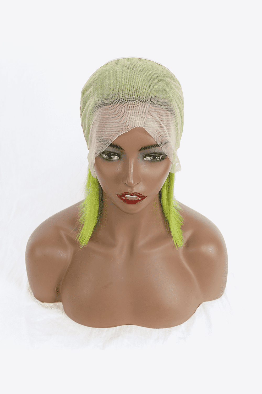 a mannequin head with a wig and green hair
