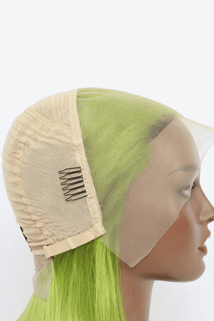 a mannequin head wearing a wig with green hair