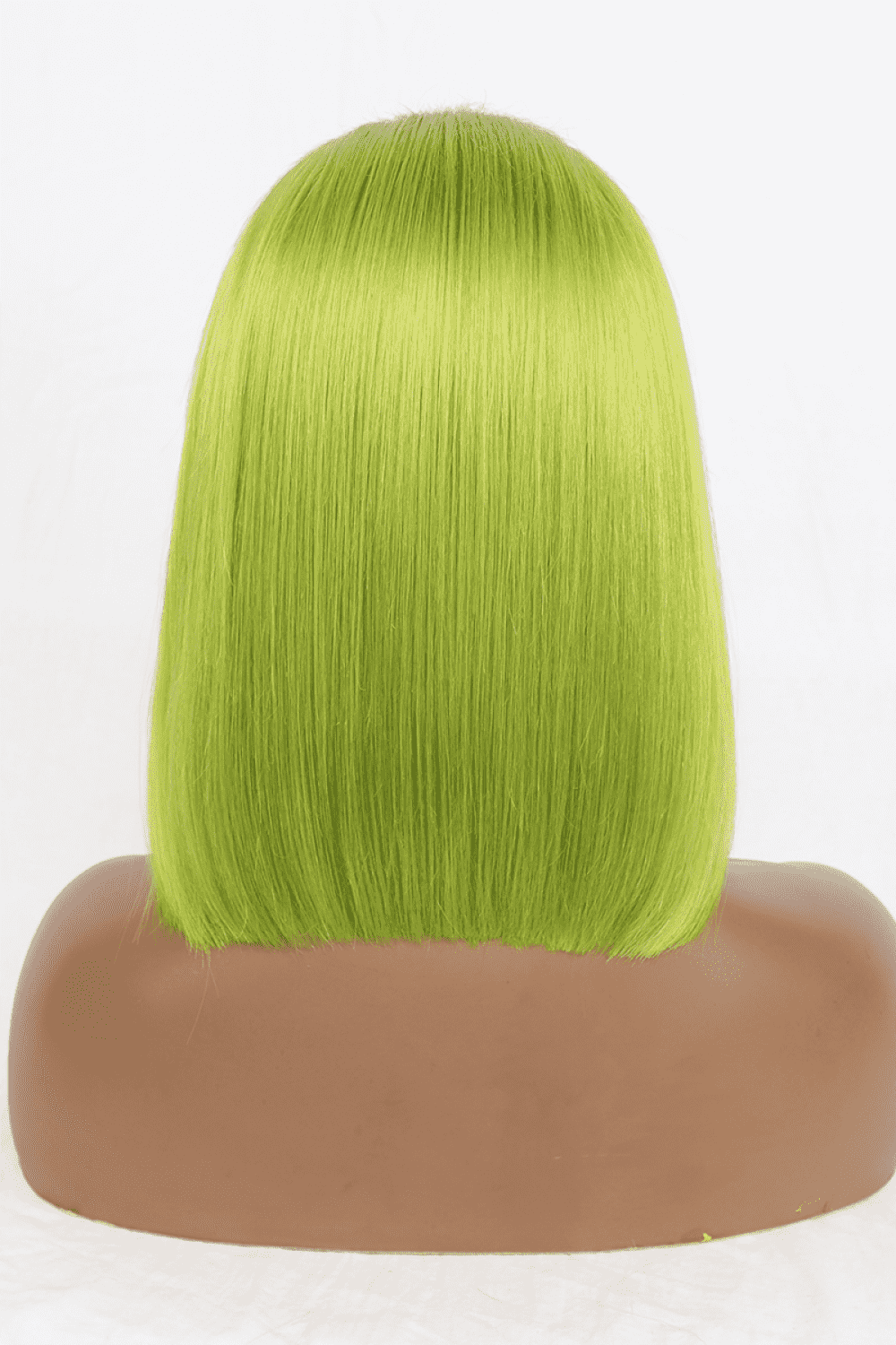 a wig with bright green hair on a mannequin head