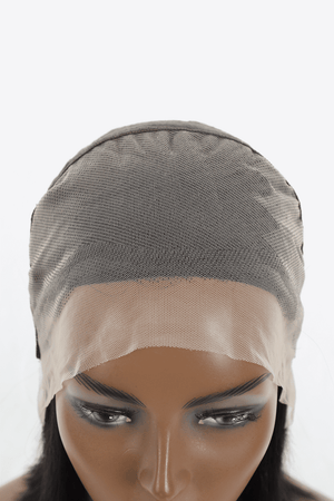 a mannequin head wearing a wig with a veil