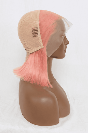 a mannequin head with a pink wig on top of it