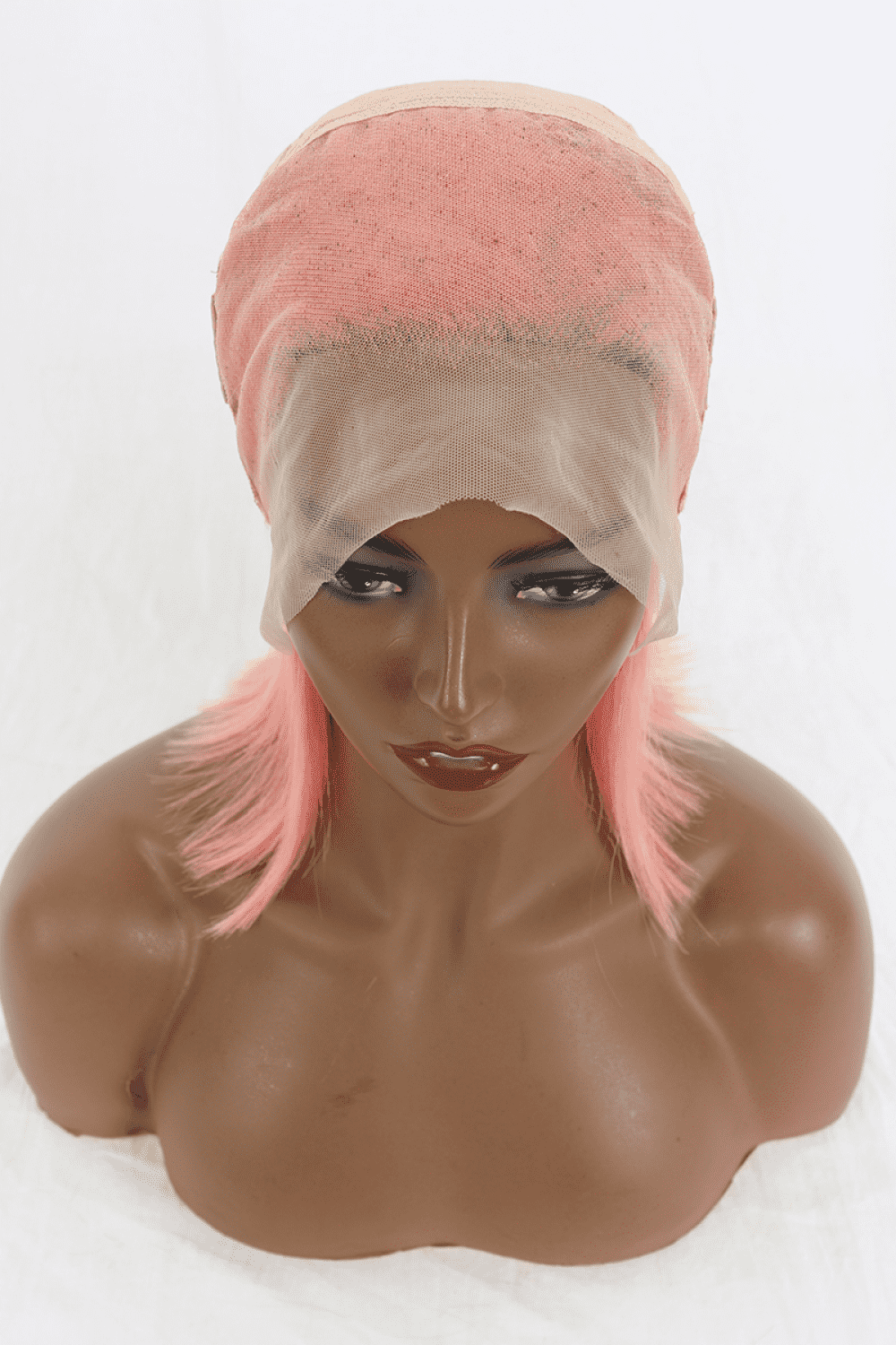 a mannequin head with a pink wig on top of it