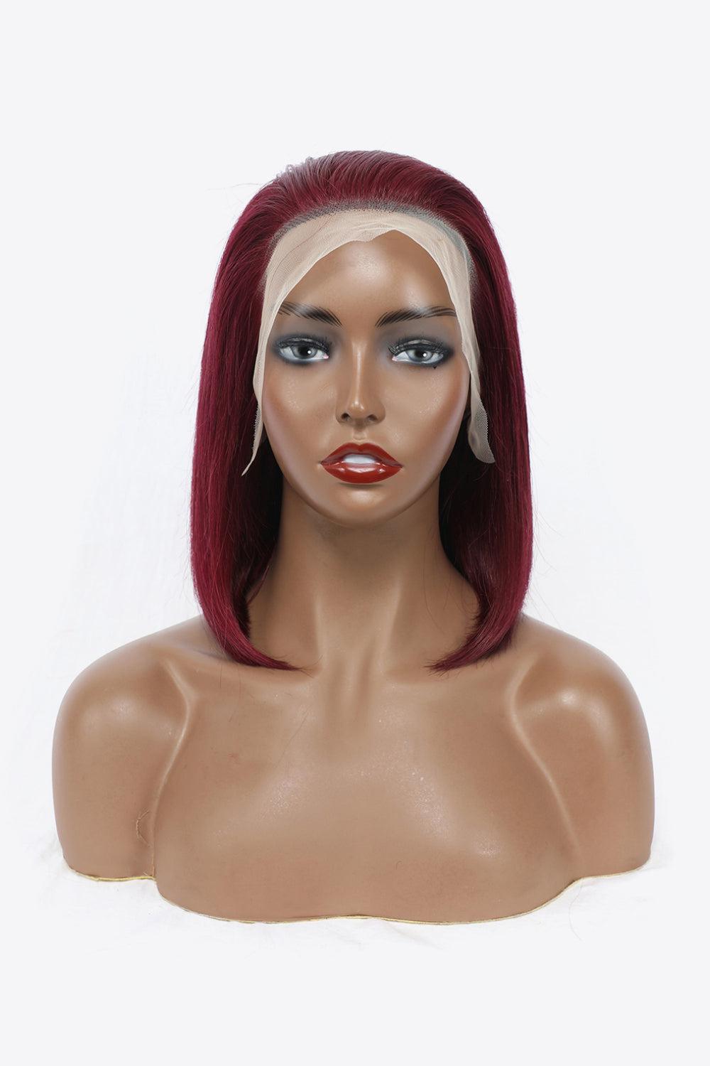 a mannequin head with a red and white wig