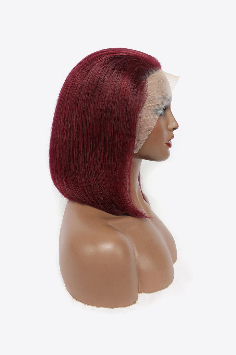 a wig with red hair on a mannequin head