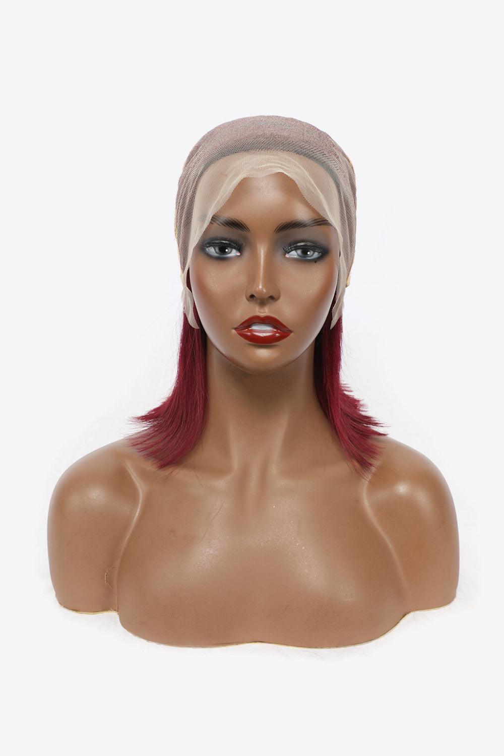 a mannequin head with red hair and a turban