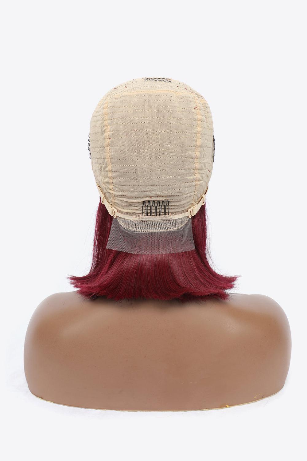 a wig with red hair on top of a mannequin head