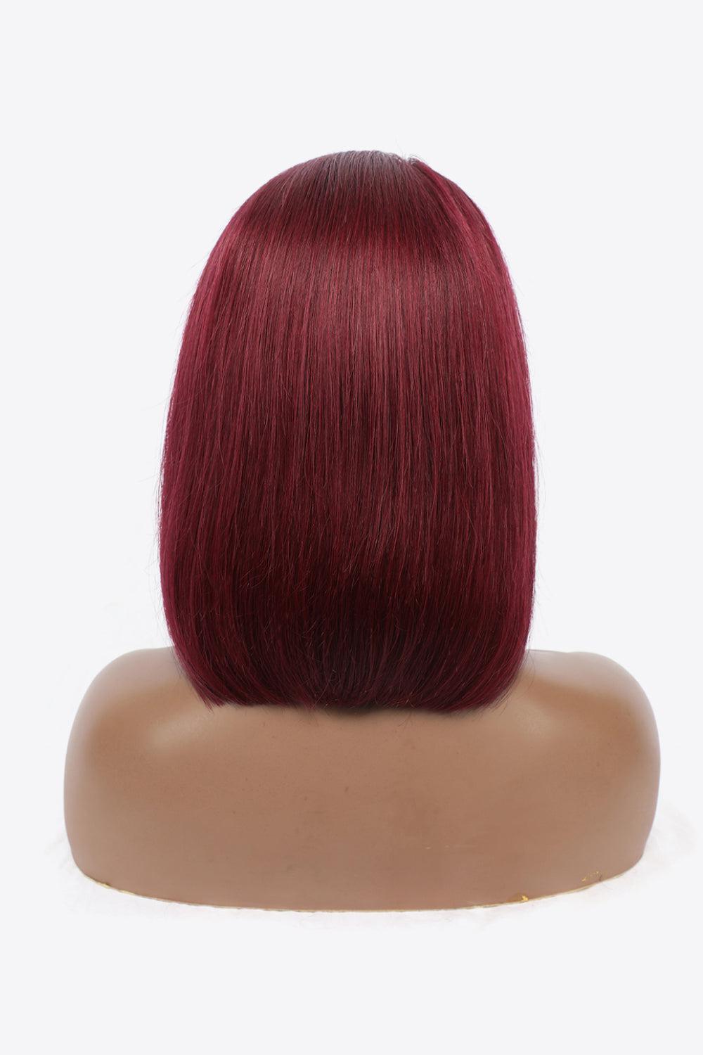 a wig with red hair on a mannequin head