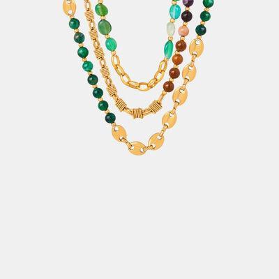 a multi - strand necklace with gold chains and multi - colored beads