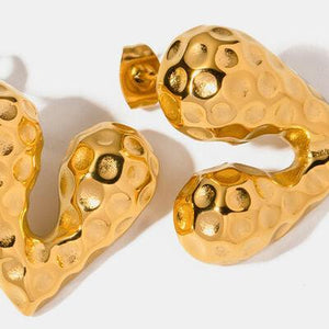 a pair of gold - plated heart shaped earrings