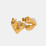 a pair of gold heart shaped earrings on a white background