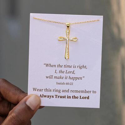 a person holding a card with a cross on it