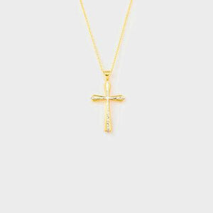 a gold cross necklace on a white background