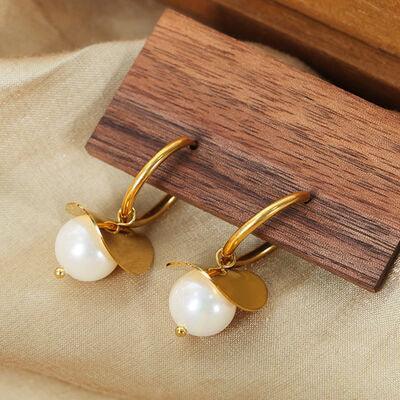 a pair of gold and white pearl earrings