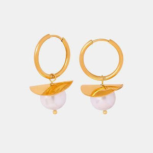 a pair of gold hoop earrings with pearls