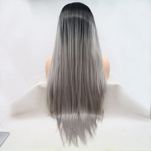 a woman with long grey hair sitting in front of a laptop computer