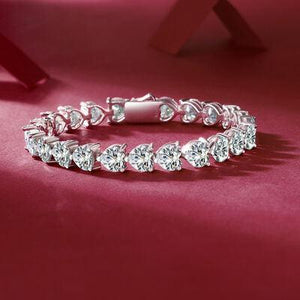 a diamond bracelet on a red surface