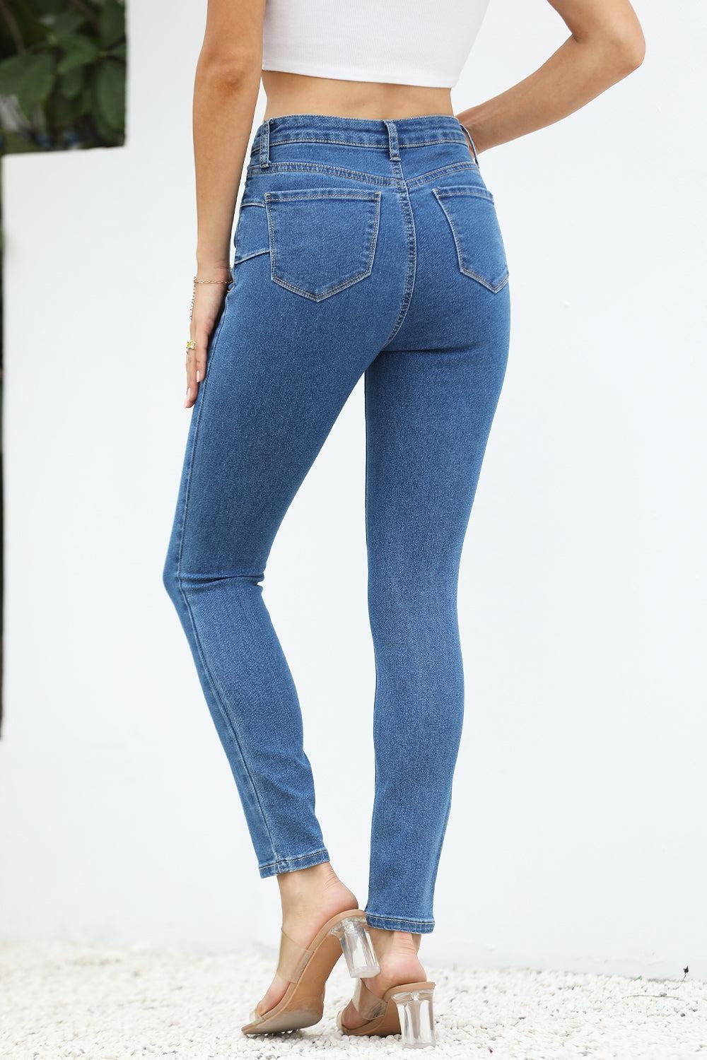 a woman wearing high rise jeans and heels