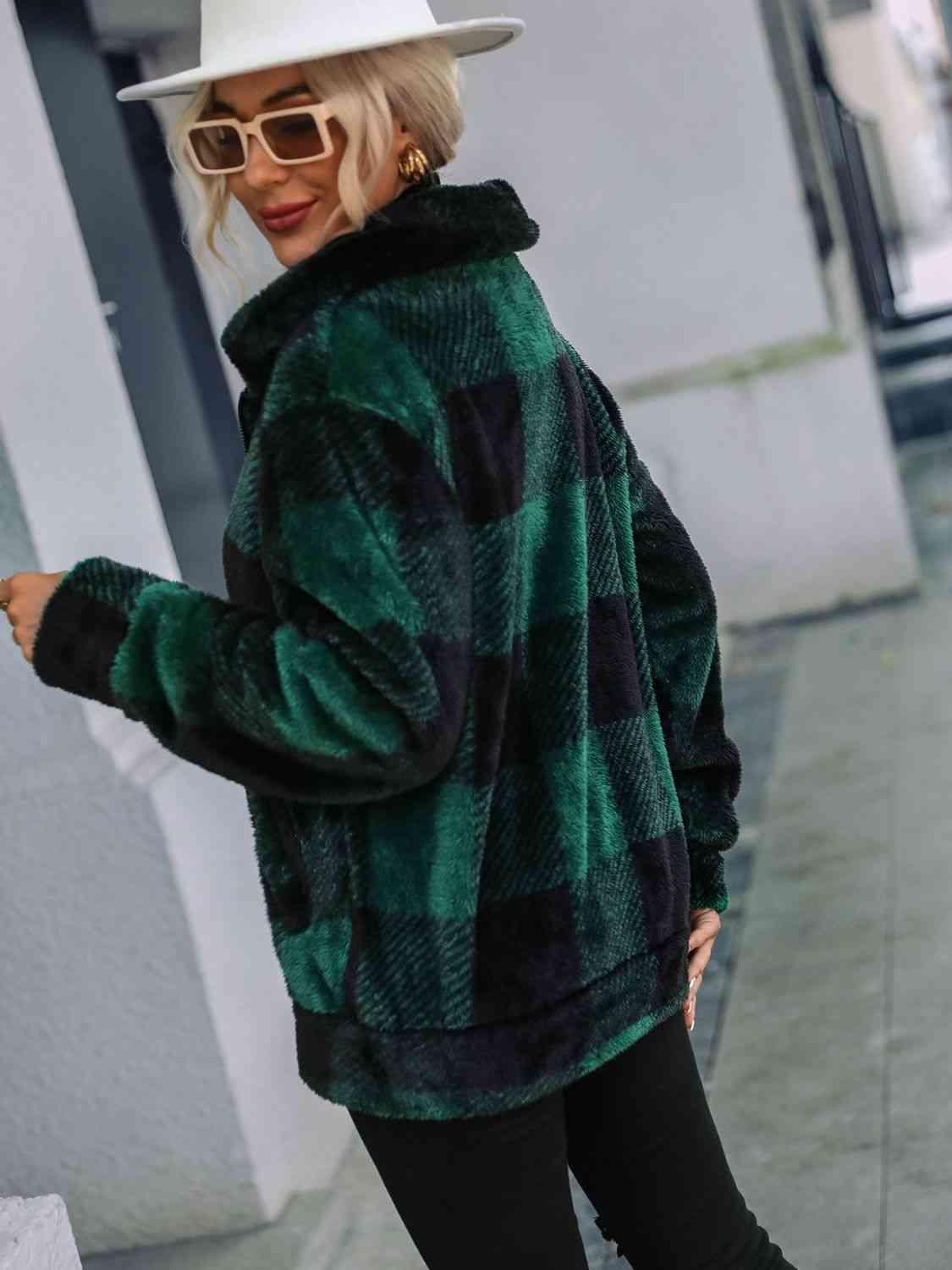 a woman wearing a green and black jacket and hat