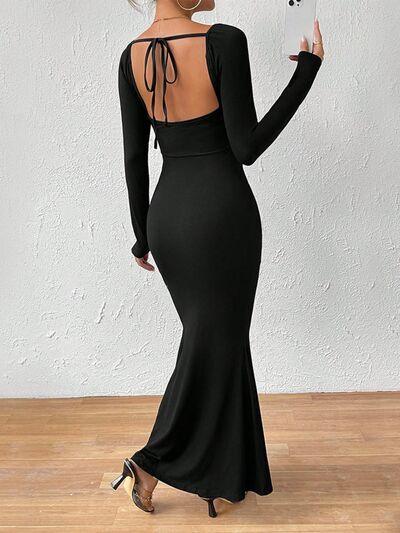 a woman in a black dress with a backless dress